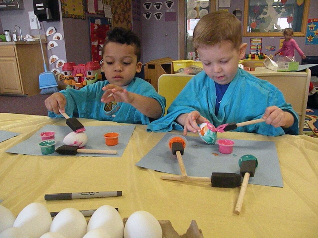Pre-School students painting Easter Eggs